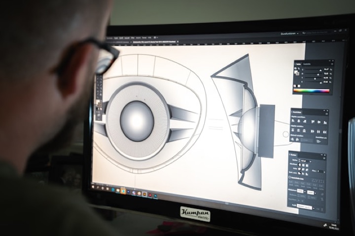 A designer shaping an illustration on screen